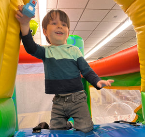 Kids zone featuring free activities like bounce houses, games, coloring, workshops, activities, and more at Undiscovered Realm Comic Con in New York.